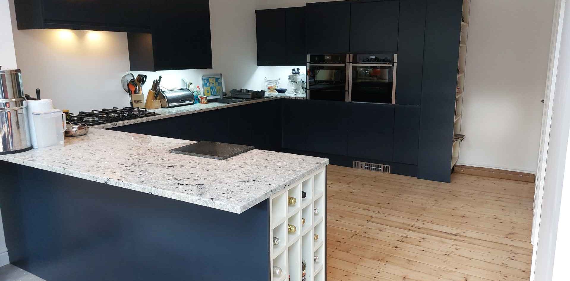 natural granite worktop and a wine rack cabinet