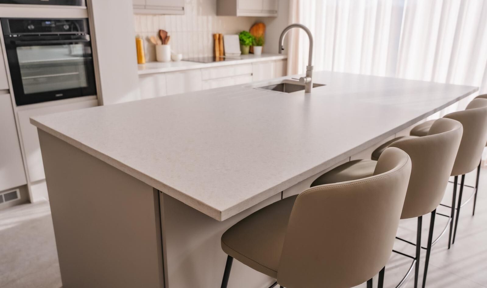 Stunning cream quartz worktop in a modern kitchen setting