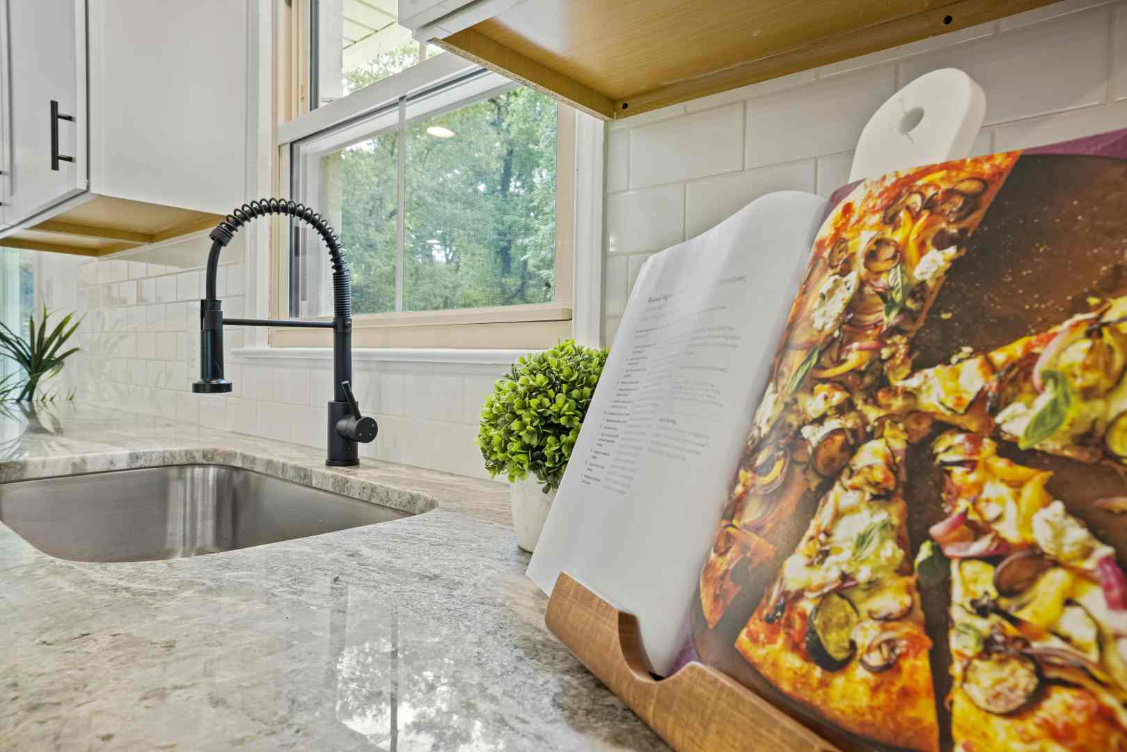 White granite worktop with a cookbook and stand